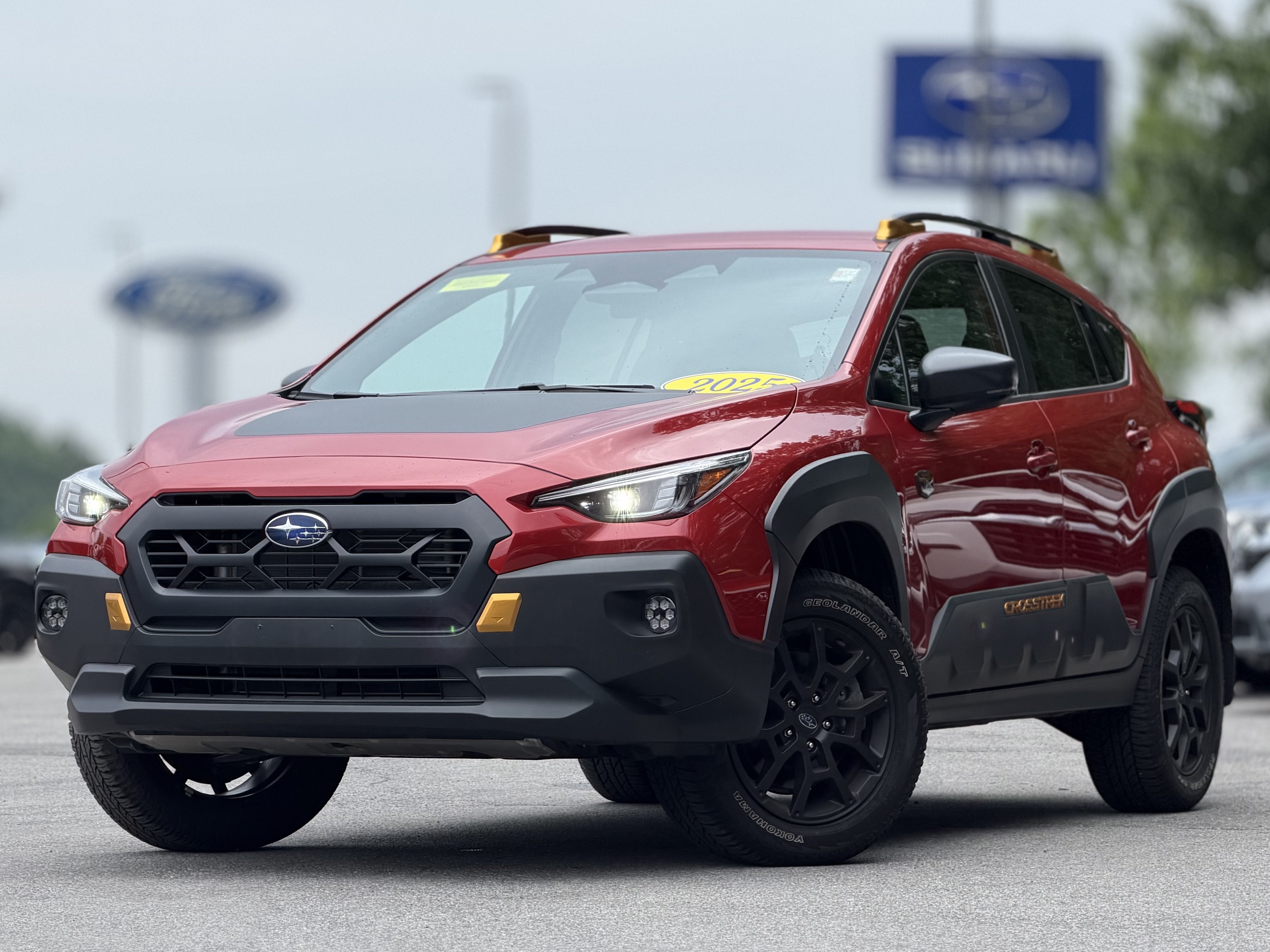 2025 Subaru Crosstrek Wilderness in Lithium Red Pearl — front three-quarter view