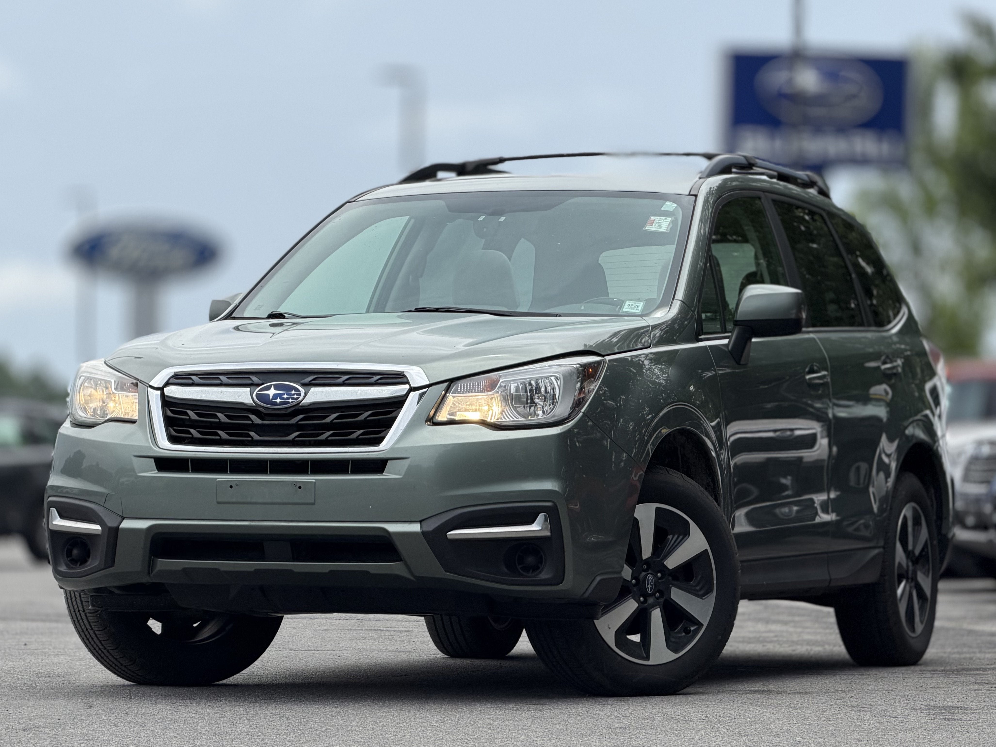 2017 Subaru Forester 2.5i Premium in Jasmine Green Metallic — front three-quarter view