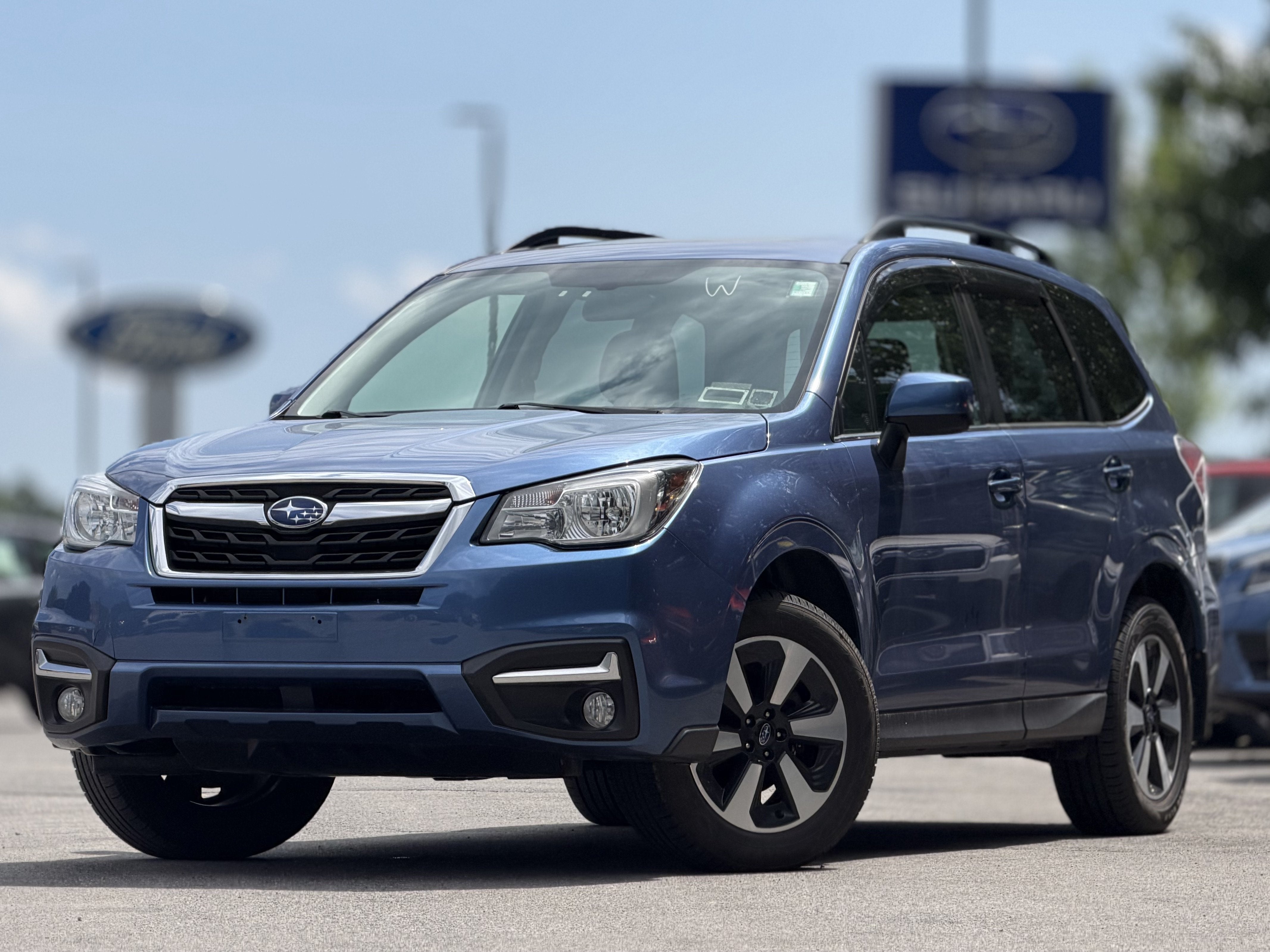 2018 Subaru Forester 2.5i Limited in Quartz Blue Pearl — front three-quarter view