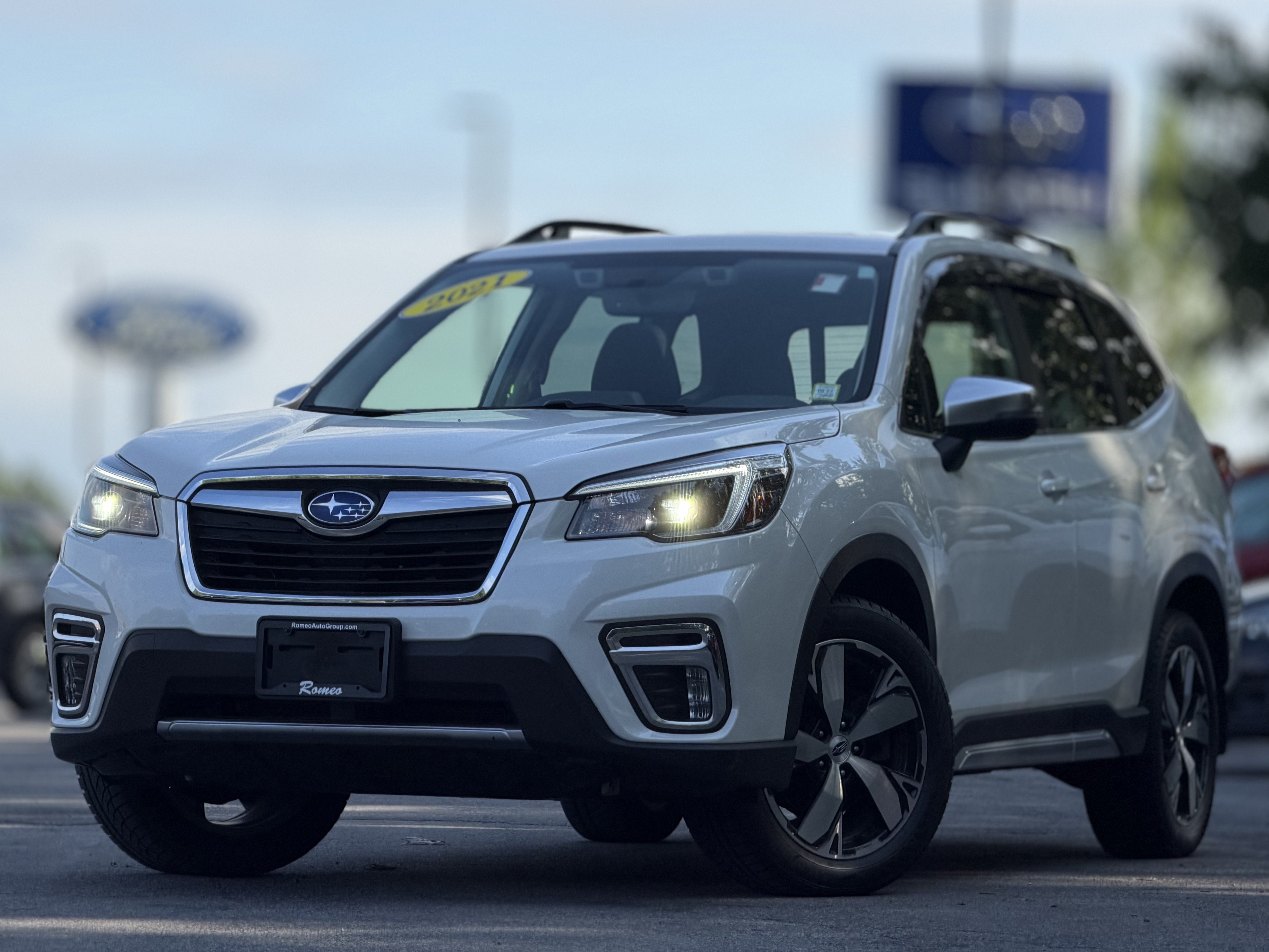 2021 Subaru Forester Touring in Crystal White Pearl — front three-quarter view